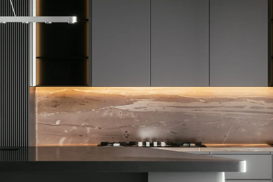 Modern kitchen with a large island in the middle of it, featuring a marble countertop with a stove