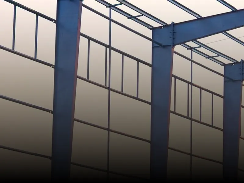 Large metal structure with a lot of windows, consisting of metal rods and a roof